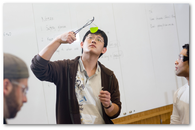 Student examining flask